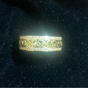 Elegant Gold plated size 8 ring with cubic zirconia stones wrapped around.